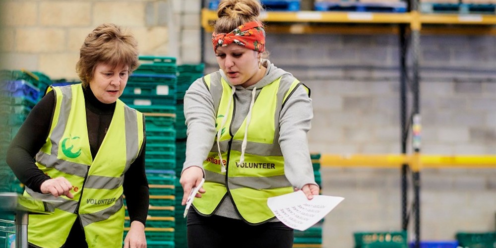 Two ladies talking in high vis jackets