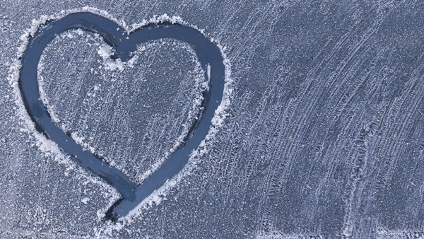 A heart shape drawn on an icy window