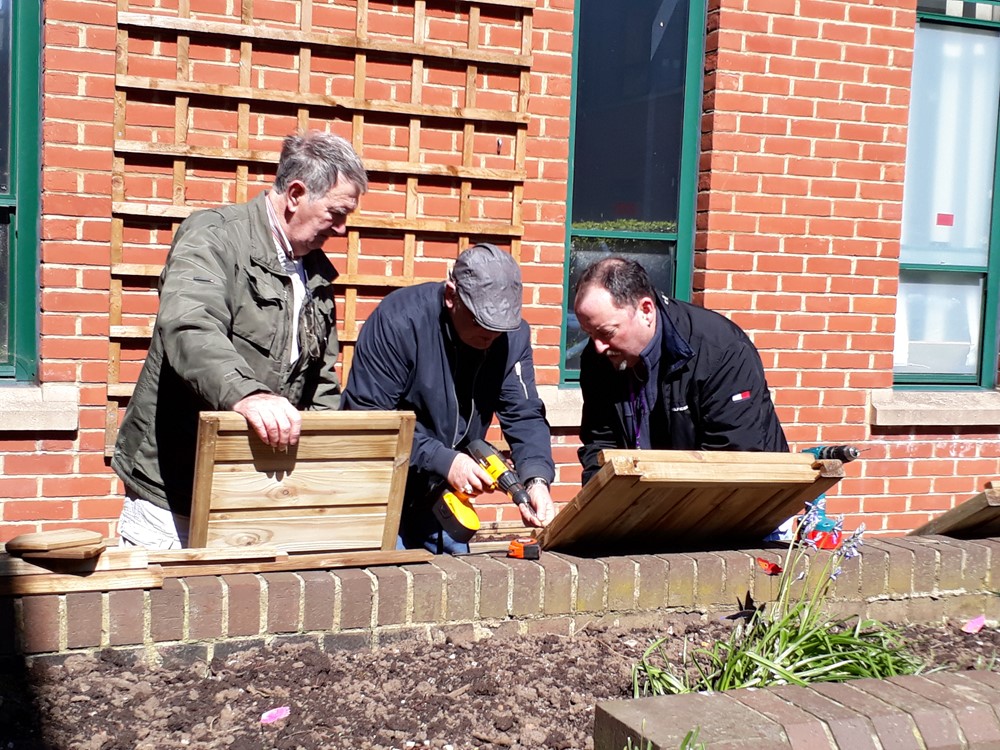 3 men building planters 