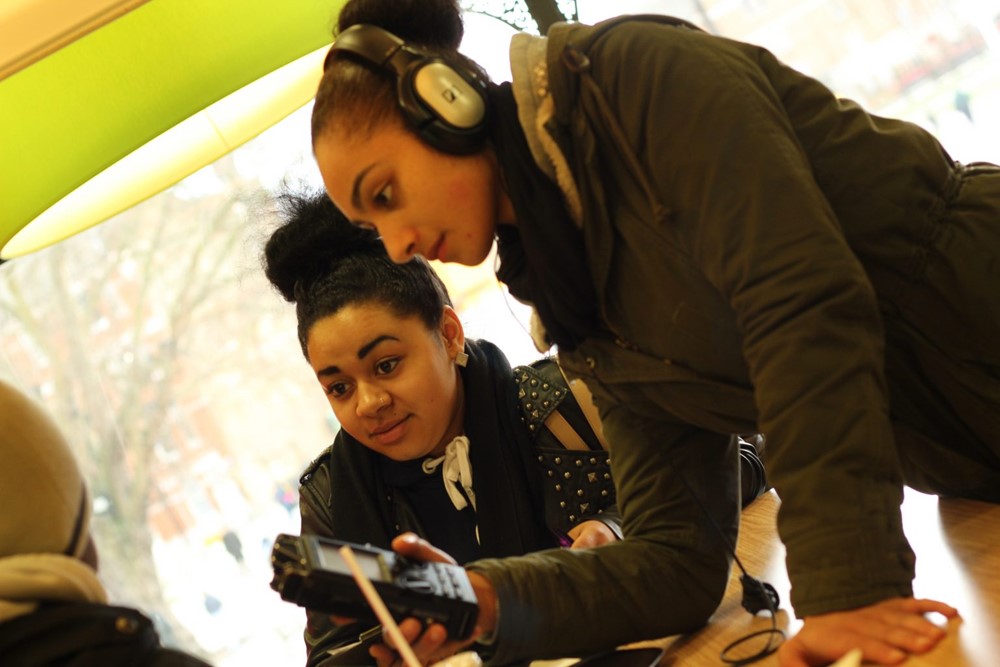 Girl with headphones on recording someone