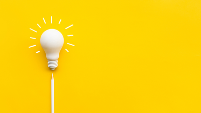 White lightbulb on a bright yellow background