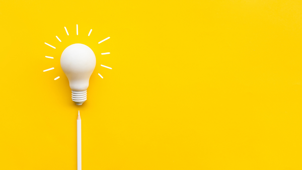 White lightbulb on a bright yellow background