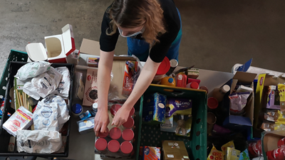 Volunteer Packs Emergency Parcels In Foodbank