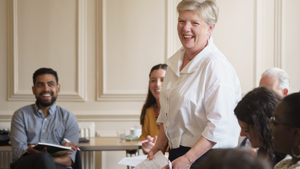 Photo of Rosemary Macdonald laughing with UKCF staff at a team meeting